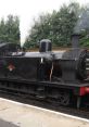 Steam locomotive chugging along a track, showcasing vintage design and powerful smoke emissions. Perfect for train enthusiasts.