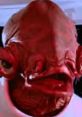 Red alien character with unique features, showcasing distinct facial structure. Iconic sci-fi figure in a futuristic setting.