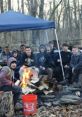 Campfire gathering at NYLT 11, featuring youth engaging in teamwork and camaraderie in a forest setting.
