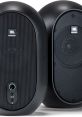 JBL professional desktop speakers featuring a sleek black design, AUX input, and adjustable volume control for enhanced audio.