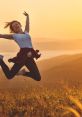 Joyful woman jumping in a field at sunset, embodying freedom and happiness in life. Vibrant colors enhance the moment.