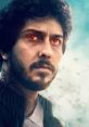 Intense character from "Mortal," showcasing fierce determination and glowing red eyes against a dramatic backdrop.