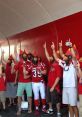 Fans in red attire celebrate with bird masks, showing team spirit for Louisville football at a lively event.