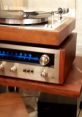 Vintage turntable with wooden finish and blue LED display, showcasing classic audio equipment design and craftsmanship.
