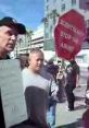 Protest against Scientology abuse, featuring activists holding signs in a public demonstration.