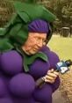 Man dressed in a grape costume holding a microphone, promoting "The Grape" event in a lively outdoor setting.
