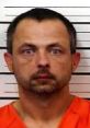 Mugshot of a man in orange prison attire, linked to crimes in Tennessee related to sexual offenses.