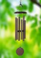 Elegant wind chime with multiple tubes and a round disc, perfect for adding soothing sounds to outdoor spaces.