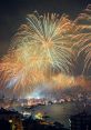 Spectacular fireworks illuminate the night sky over a cityscape, perfect for a New Year's celebration atmosphere.