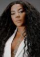 Ludmilla showcasing her elegant style with curly hair and a chic outfit, exuding confidence and glamour.