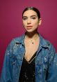 Dua Lipa showcases her chic style in a embellished denim jacket against a vibrant pink backdrop. Perfect for fashion enthusiasts.