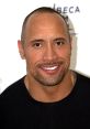 Dwayne Johnson smiling at a red carpet event, showcasing his charismatic personality and signature style.