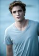 Edward stands thoughtfully in a light blue shirt, gazing into the distance with striking golden eyes.