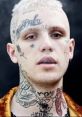 Portrait of a young man with distinctive tattoos and platinum blonde hair, showcasing a bold, alternative style.