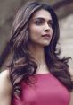 Deepika displaying elegance with flowing hair and a radiant expression in a chic pink dress.