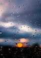 Raindrops on a window during sunset, showcasing nature's beauty and the serenity of a rainy evening.