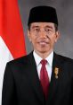 Joko Widodo, President of Indonesia, in formal attire with a black headwear against the national flag backdrop.