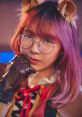 Lilypichu showcasing a playful look with cat-themed accessories and vibrant hair in a creative setting.