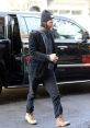 Keanu Reeves steps out in a stylish outfit, showcasing his casual yet chic fashion sense on a city street.