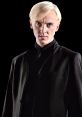Draco Malfoy in a sleek black suit, exuding confidence and a hint of arrogance from the Harry Potter movie series.