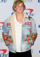 Logan Paul poses in a stylish embroidered denim jacket, showcasing his unique fashion sense at the event.