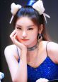 Yeji from ITZY showcases her unique style with cat ear accessories and stunning makeup, exuding confidence and charisma.