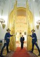 Vladimir Putin walks through grand doors adorned with gold, flanked by guards in ceremonial uniforms, in a lavish hall.