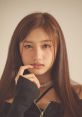 LeeSeo from IVE poses thoughtfully, showcasing her signature style and captivating expressive gaze.