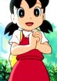 Cheerful Shizuka Minamoto from Doraemon, wearing a red dress, with hands clasped and a bright smile, surrounded by greenery.