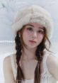 Huh Yunjin of LE SSERAFIM in a cozy fur hat, showcasing elegance in a winter-themed photoshoot.