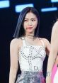 Ryujin from ITZY showcases stunning style in a chic, studded outfit during a live performance, captivating the audience.