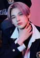 Ni-ki from ENHYPEN showcases a stylish look with pastel hair and a confident pose, capturing K-pop's vibrant culture.