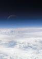 Serene view of Earth's atmosphere showcasing clouds against a dark sky, highlighting the beauty of our planet's layers.