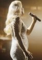 Dramatic performance featuring a singer with microphone, highlighting captivating stage presence and vocal talent.