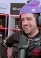 Auron's charismatic streaming moment, wearing a purple beanie and enjoying his time on Twitch.
