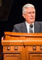 Dieter F. Uchtdorf speaks at a podium, sharing insights and guidance during a Church of Jesus Christ event.