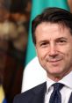 Giuseppe Conte smiles confidently against a backdrop of Italian flags, representing his leadership and political presence.