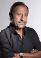 Guillermo Francella, distinguished actor, posing confidently in a black shirt with a watch, exuding charisma and elegance.