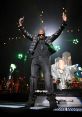 Jay-Z performing live on stage with dynamic lights, showcasing his iconic style and engaging the audience in the moment.