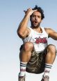 Jordi Wild shows dynamic energy, posing in camo shorts and a tank top, embodying the spirit of El Rincón de Giorgio.