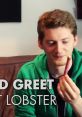 Matt Lobster smiles while holding a snack, wearing a green hoodie in a casual setting. Perfect for fan interactions.
