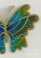 Colorful butterfly design by Pat Fleet featuring blue and green hues with glitter accents. Ideal for art lovers and decor enthusiasts.