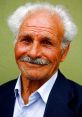 Elderly man with white hair and mustache, smiling warmly against a green background, representing local Sicilian culture.