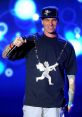 Vanilla Ice performing on stage, wearing a unique shirt and cap, showcasing his iconic style and vibrant personality.
