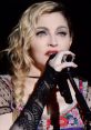 Madonna performing passionately on stage, captivating the audience with her dynamic vocals and striking style.