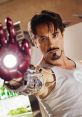 Tony Stark, portrayed by Robert Downey Jr., showcases his iconic Iron Man suit and glowing arc reactor.