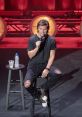 Theo Von delivering a stand-up comedy routine on stage, showcasing his unique style and engaging performance.