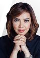 Najwa Shihab, Indonesian journalist, showcasing thoughtful expression with hands clasped, in a professional setting.
