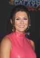 Cerina Vincent smiling in a stylish pink dress at a red carpet event, highlighting her glamour and confidence.