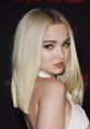 Dove Cameron showcases a stunning look with sleek blonde hair and striking makeup at a red carpet event.